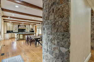 Dining area featuring beamed ceiling and light hardwood / wood-style flooring