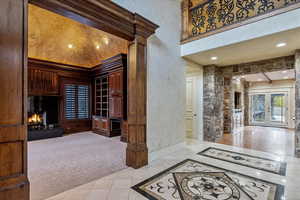 Interior space with light tile patterned floors, a high ceiling, and french doors