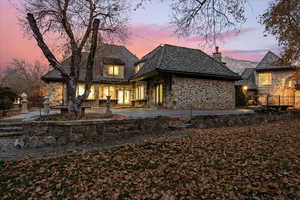 Back house at dusk featuring a patio area