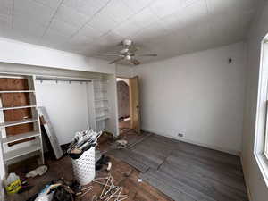 Unfurnished bedroom featuring ceiling fan and dark hardwood / wood-style floors