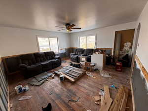 Living room with a fireplace, hardwood / wood-style floors, and ceiling fan