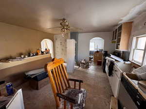 Kitchen featuring ceiling fan and white cabinetry