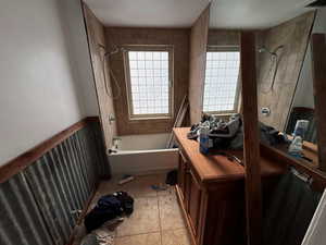 Bathroom with tile patterned flooring and tiled shower / bath combo