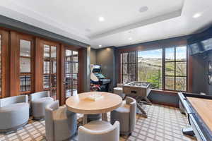 Dining room featuring a tray ceiling and french doors