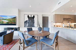 Dining space featuring light hardwood / wood-style floors and lofted ceiling