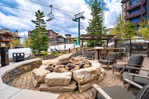 View of patio with exterior bar and an outdoor fire pit