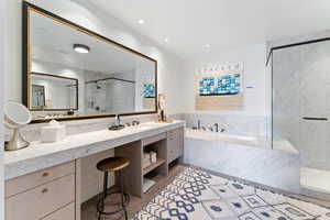 Bathroom featuring wood-type flooring, vanity, and separate shower and tub