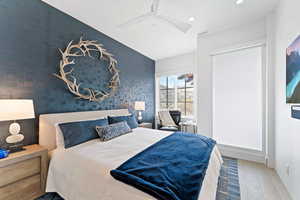 Bedroom featuring ceiling fan and wood-type flooring