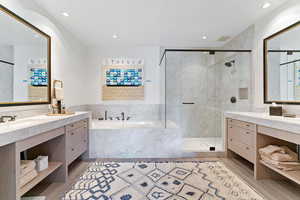 Bathroom with shower with separate bathtub, vanity, and hardwood / wood-style flooring