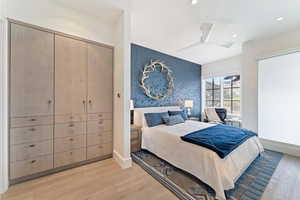 Bedroom with light hardwood / wood-style flooring and ceiling fan