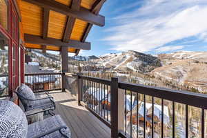 Snow covered deck with a mountain view