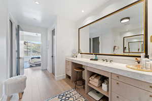 Bathroom with hardwood / wood-style flooring and vanity