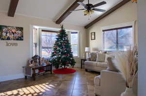 Living room with vaulted ceiling with beams and ceiling fan