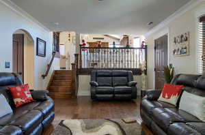 Living room with crown molding and dark hardwood / wood-style floors