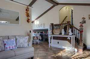 Living room featuring vaulted ceiling and ceiling fan