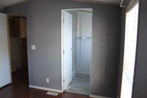 Corridor featuring dark hardwood / wood-style floors