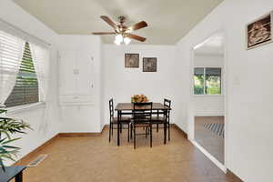 Dining area featuring light tile patterned floors and a ceiling fan