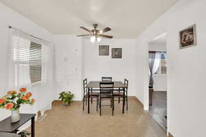 Tiled dining area with a wealth of natural light and ceiling fan