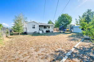 Back of property featuring a trampoline and a fenced backyard