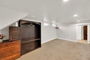 Below grade area featuring carpet floors and recessed lighting