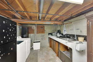 Basement featuring sink and independent washer and dryer