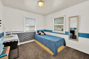 Bedroom featuring carpet floors and baseboards