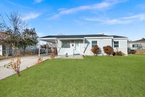 View of front of house with a carport and a front yard