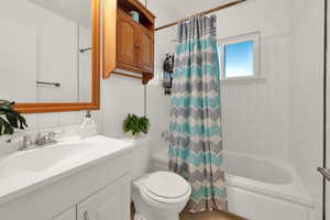 Bathroom with shower / bath combo and vanity