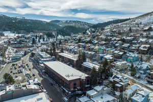 Snowy aerial view featuring a mountain view