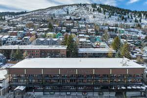 Snowy aerial view featuring a mountain view