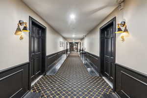 Hallway with dark carpet