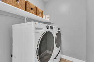 Laundry room featuring light tile patterned floors and independent washer and dryer