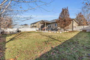 Rear view of house with a lawn