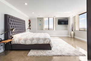 Bedroom with concrete floors and ornamental molding