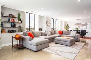 Living room featuring concrete flooring and crown molding