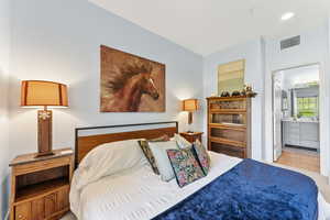 Bedroom featuring ensuite bath and light hardwood / wood-style flooring