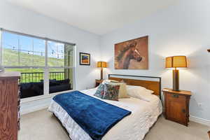 Bedroom with light colored carpet