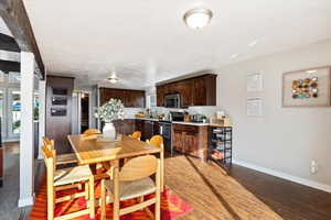 Dining room with sink, a textured ceiling, and hardwood / wood-style flooring