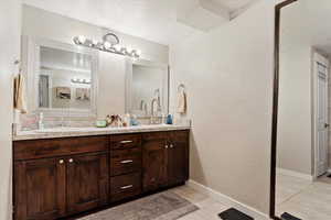 Bathroom with tile patterned floors and vanity