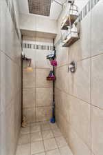 Bathroom featuring tile patterned floors and a tile shower