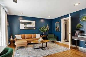 Living room with hardwood / wood-style floors and a textured ceiling