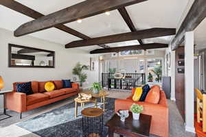 Living room with beamed ceiling and carpet floors