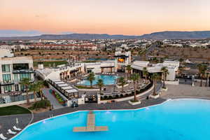 Pool at dusk featuring a mountain view