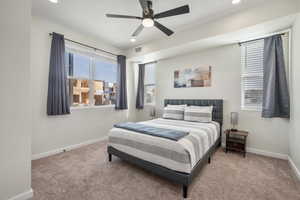 Carpeted bedroom with ceiling fan