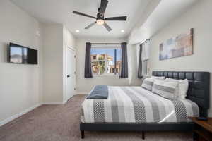 Carpeted bedroom with ceiling fan