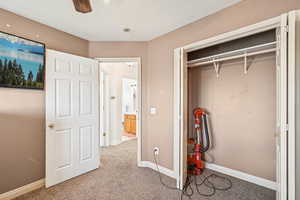 Unfurnished bedroom with carpet flooring, a closet, and ceiling fan