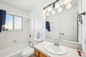 Full bathroom with vanity, shower / bathing tub combination, and toilet