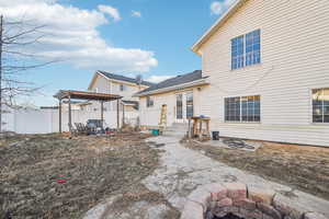 Back of house featuring a pergola and a patio area