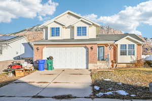 View of property with a mountain view and a garage