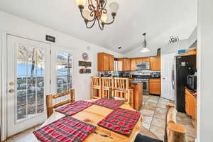 Dining room with a notable chandelier and lofted ceiling